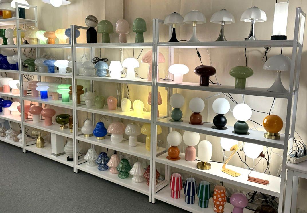 Colorful mushroom table lamps in green, burgundy, orange and yellow with matching pendant lights overhead